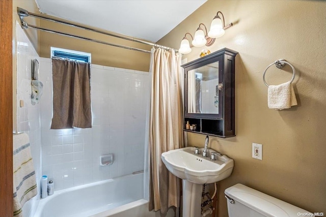 full bathroom featuring sink, shower / tub combo, and toilet