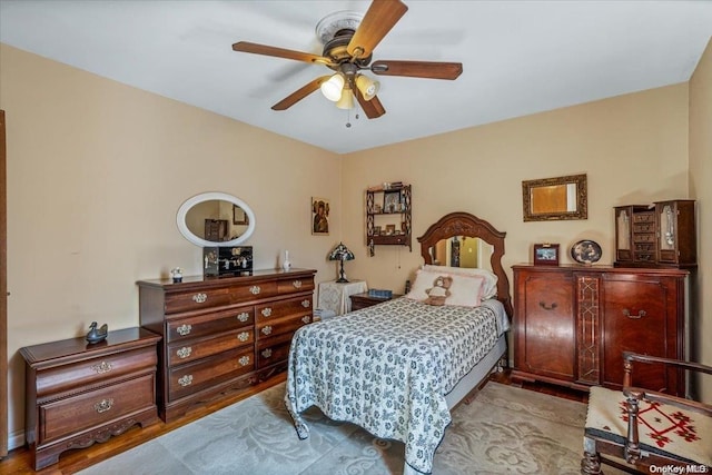 bedroom with light hardwood / wood-style floors and ceiling fan