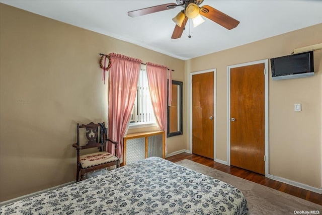 bedroom with ceiling fan and dark hardwood / wood-style floors