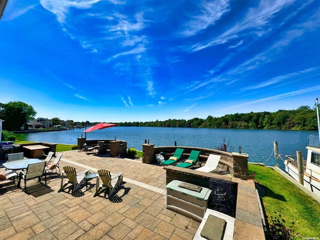 view of patio / terrace featuring a boat dock and a water view