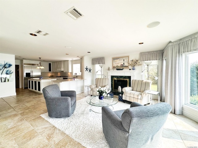 living room featuring sink and a fireplace