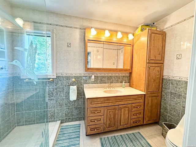 bathroom featuring tile patterned flooring, an enclosed shower, toilet, vanity, and tile walls