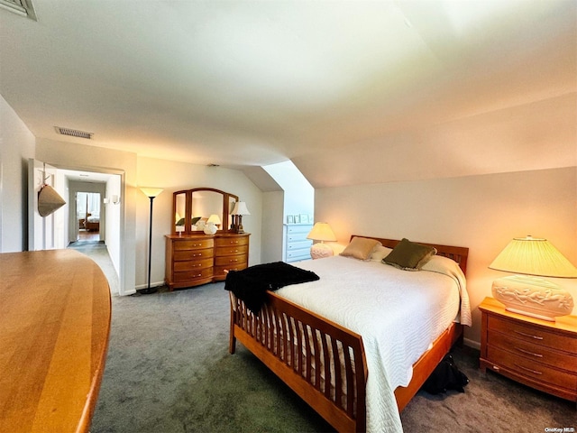 carpeted bedroom with lofted ceiling