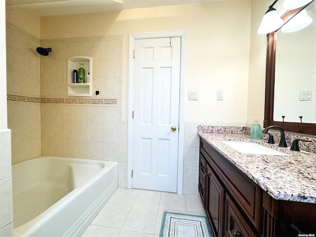 bathroom featuring tile patterned flooring, vanity, tile walls, and tiled shower / bath