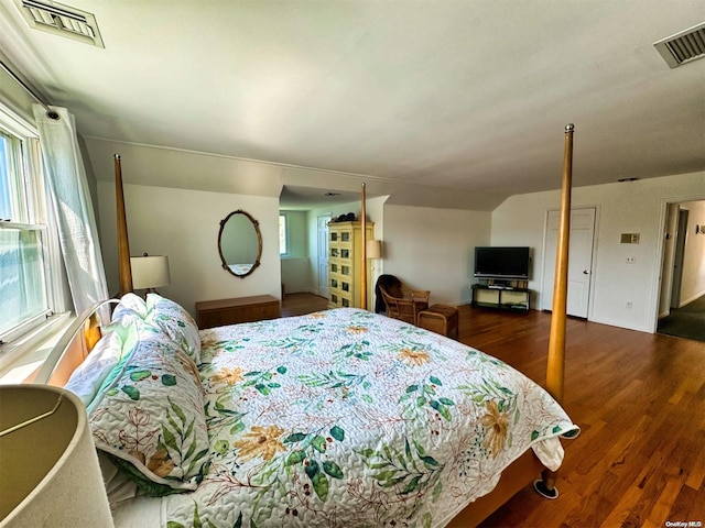 bedroom featuring dark hardwood / wood-style floors and multiple windows