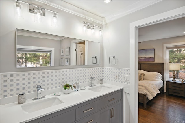 bathroom with wood-type flooring, crown molding, and a healthy amount of sunlight