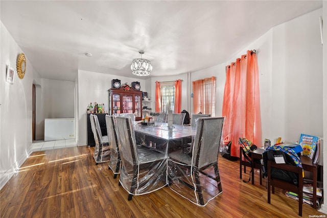 dining room with a notable chandelier and hardwood / wood-style flooring