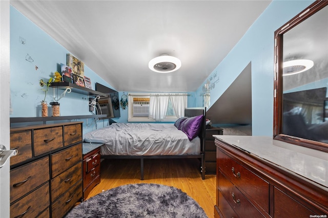 bedroom featuring light hardwood / wood-style floors and lofted ceiling