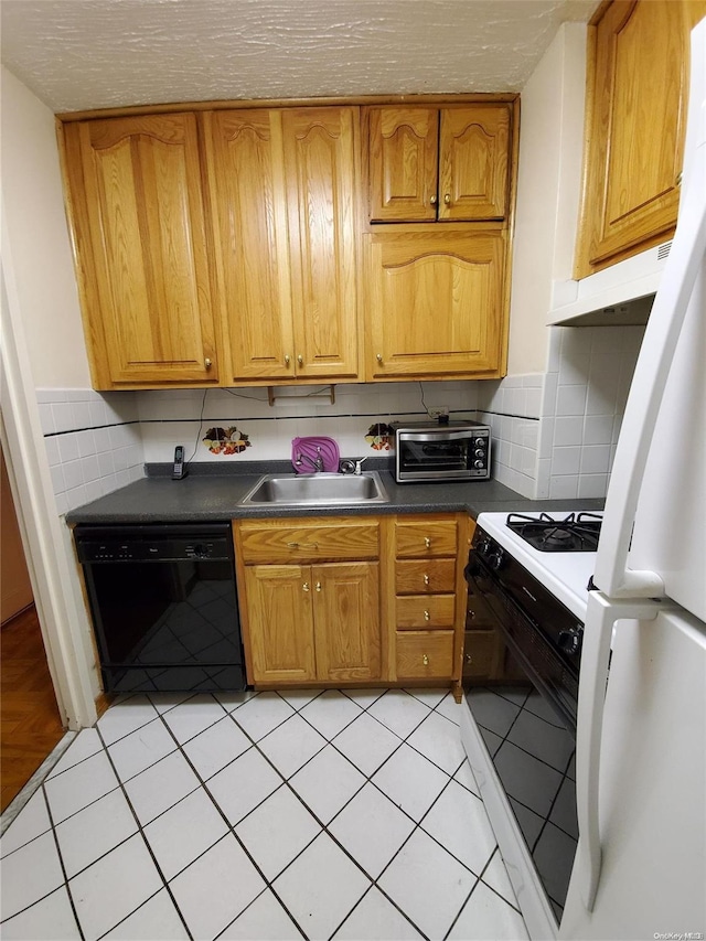 kitchen featuring tasteful backsplash, sink, light tile patterned flooring, and white appliances