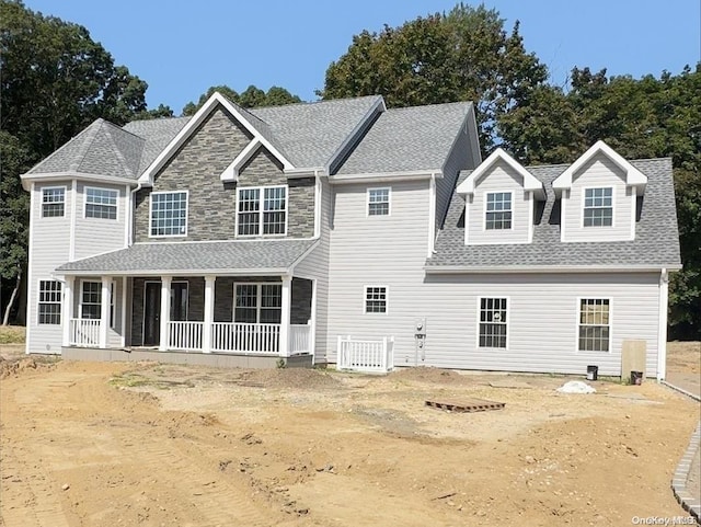 view of front of house with a porch and central AC