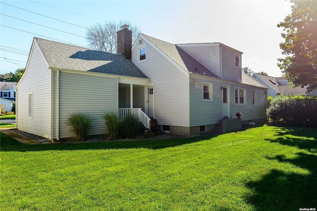 rear view of property with a yard