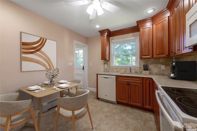 kitchen with tasteful backsplash, white appliances, ceiling fan, a baseboard heating unit, and sink