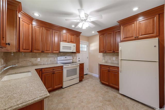 kitchen featuring decorative backsplash, light stone counters, white appliances, ceiling fan, and sink