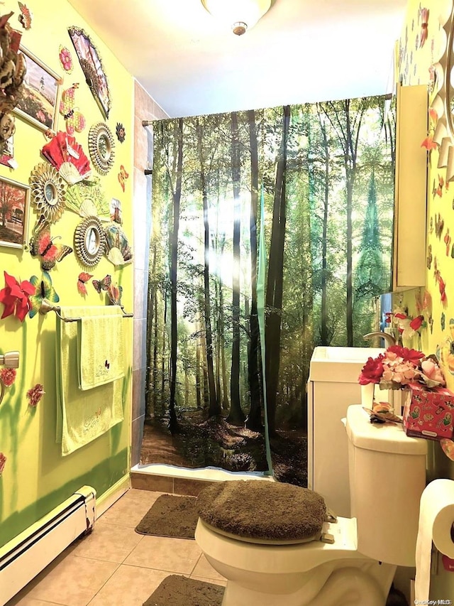 bathroom with toilet, a healthy amount of sunlight, tile patterned floors, and a baseboard heating unit