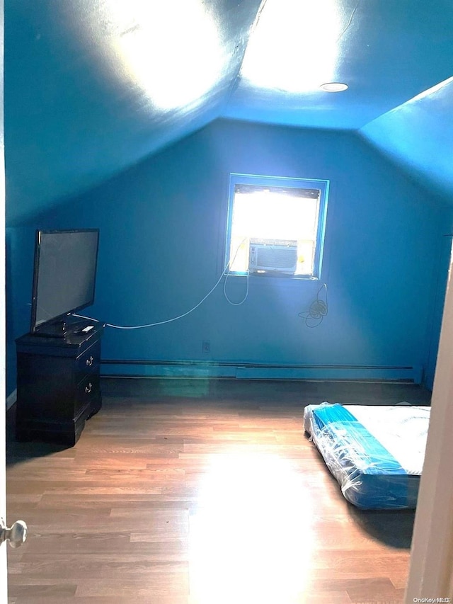 bonus room with cooling unit, wood-type flooring, and vaulted ceiling