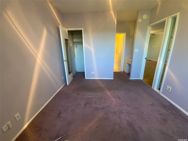 unfurnished bedroom featuring dark carpet