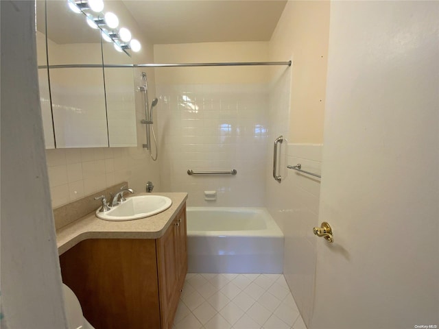 bathroom featuring decorative backsplash, vanity, tiled shower / bath, and tile patterned flooring