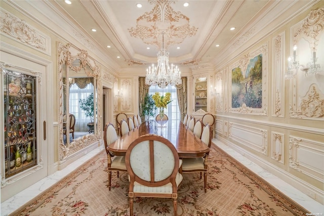 dining room with a raised ceiling, an inviting chandelier, and ornamental molding