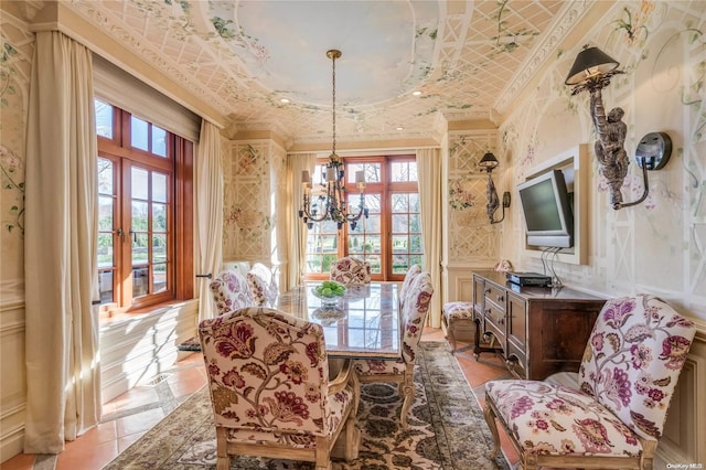 dining space featuring french doors and a chandelier