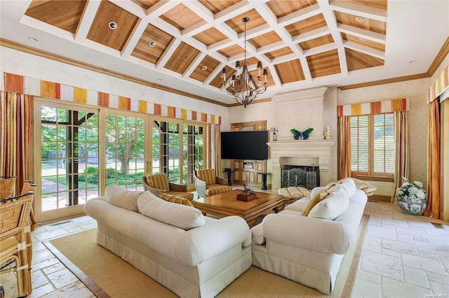 living room featuring plenty of natural light, high vaulted ceiling, and an inviting chandelier