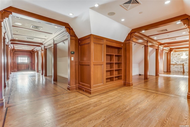 additional living space with light hardwood / wood-style floors and lofted ceiling