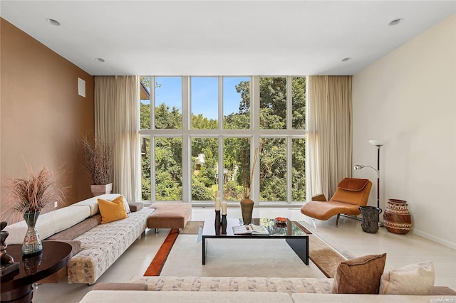 living room with floor to ceiling windows and a healthy amount of sunlight