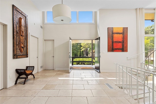 foyer featuring a towering ceiling