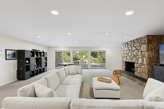 carpeted living room with a fireplace