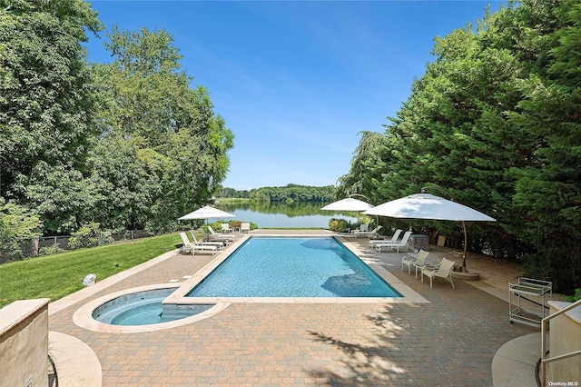 view of swimming pool with a patio area, an in ground hot tub, a yard, and a water view