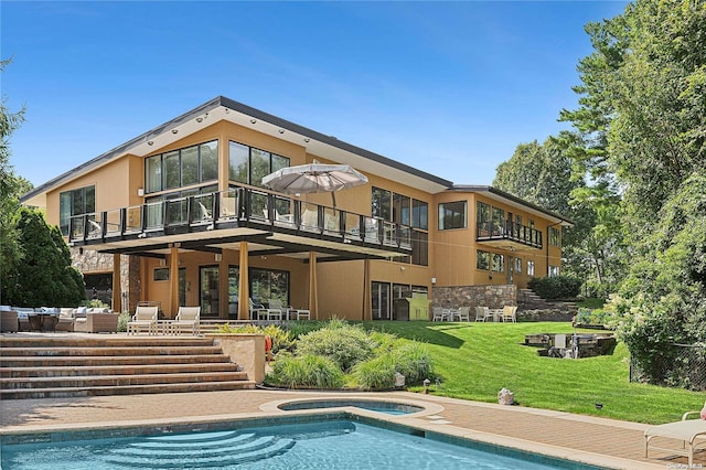 back of house with a patio, a balcony, and a lawn