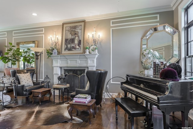 sitting room with dark hardwood / wood-style flooring and crown molding