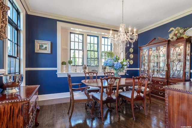 dining space featuring a notable chandelier, dark hardwood / wood-style flooring, and crown molding