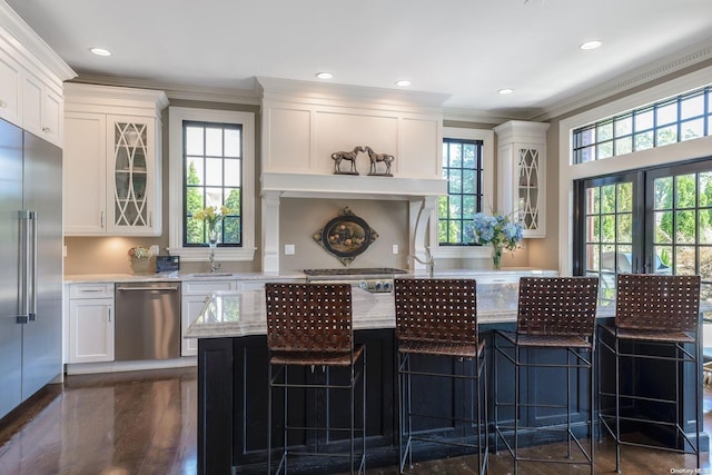 1974 Monroe Ave, North Bellmore, NY 11710 - kitchen with stainless steel appliances, ornamental molding, white cabinetry, glass insert cabinets, and a sink