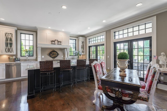 dining room featuring french doors, ornamental molding, plenty of natural light, and dark wood-type flooring