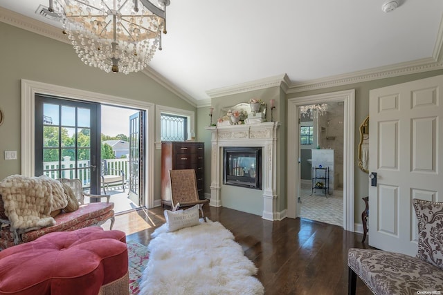 1974 Monroe Ave, North Bellmore, NY 11710 - living room with wood finished floors, a glass covered fireplace, vaulted ceiling, a chandelier, and crown molding