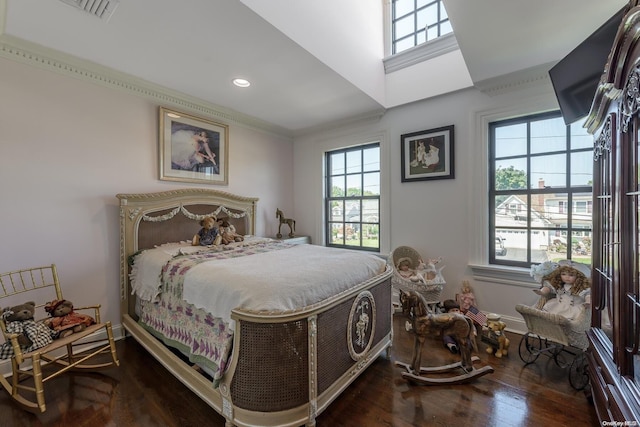 bedroom featuring crown molding and dark wood-type flooring