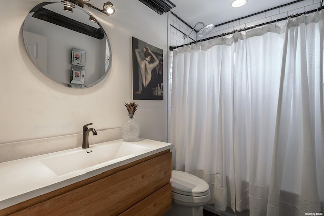 bathroom featuring vanity, curtained shower, and toilet