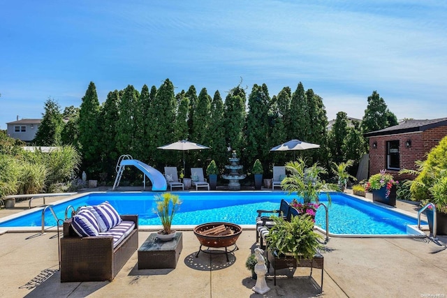 1974 Monroe Ave, North Bellmore, NY 11710 - outdoor pool with a water slide, a fire pit, and a patio area