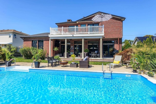 view of pool with a patio, an outdoor living space with a fire pit, and a water slide