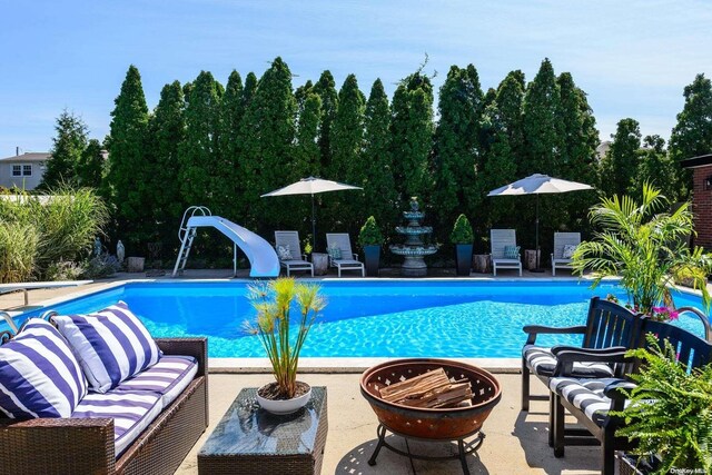 1974 Monroe Ave, North Bellmore, NY 11710 - outdoor pool with a water slide, a patio area, and an outdoor living space