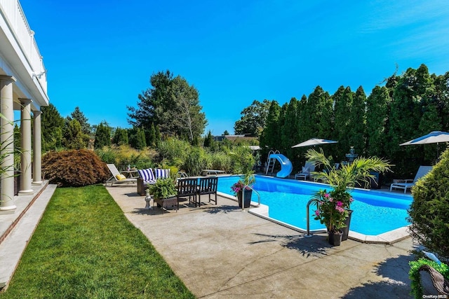 1974 Monroe Ave, North Bellmore, NY 11710 - swimming pool featuring a water slide, a patio, a diving board, and a yard