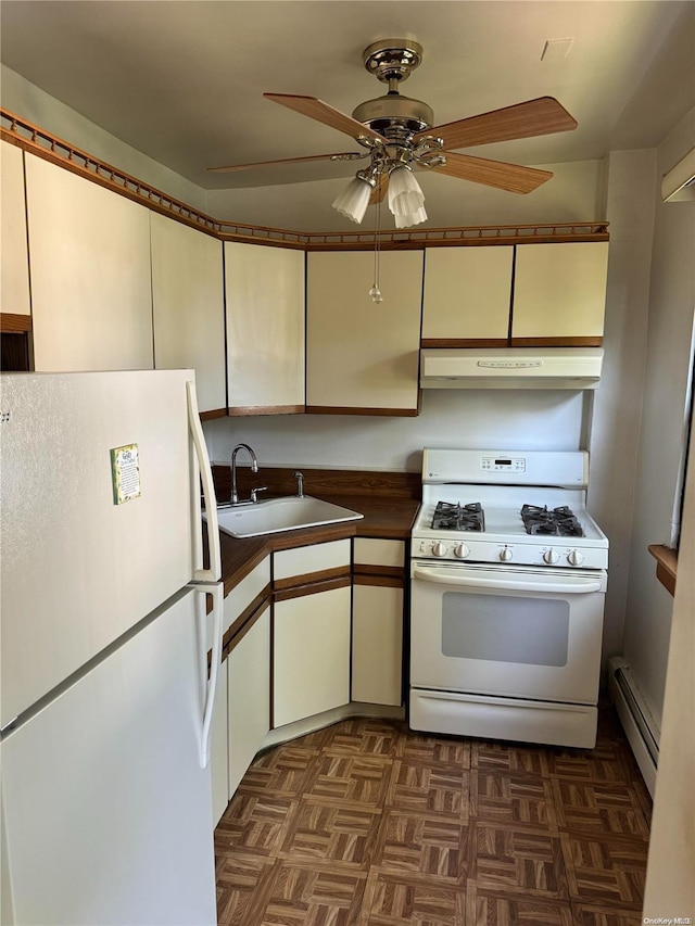 kitchen with white appliances, dark parquet floors, sink, ceiling fan, and a baseboard radiator