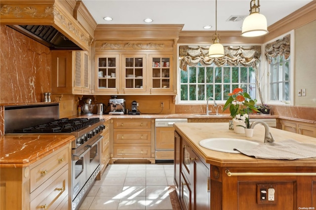 kitchen featuring a center island with sink, high end range, white dishwasher, and sink