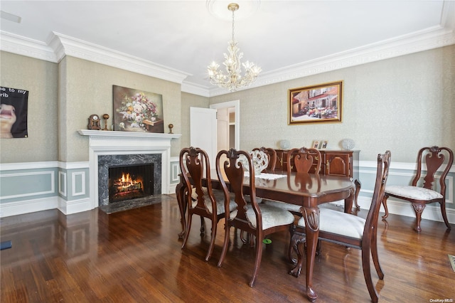 dining area with a fireplace, dark hardwood / wood-style floors, an inviting chandelier, and crown molding