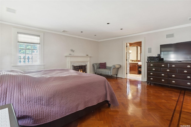 bedroom with connected bathroom, crown molding, and dark parquet floors