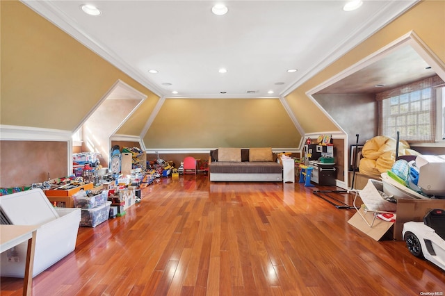 rec room featuring ornamental molding, lofted ceiling, and hardwood / wood-style flooring