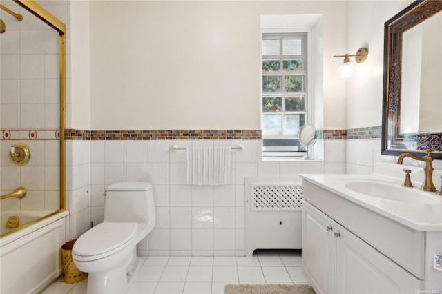 full bathroom featuring vanity, tile patterned floors, toilet, enclosed tub / shower combo, and tile walls