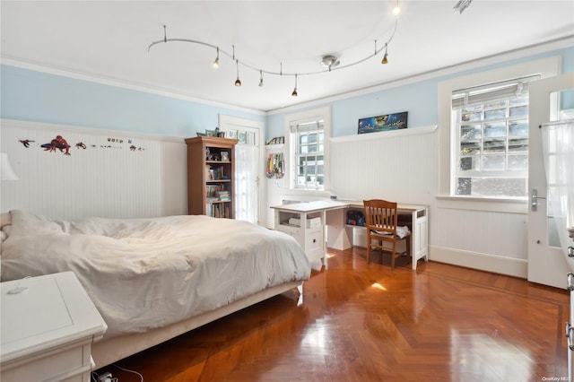 bedroom featuring crown molding and parquet floors