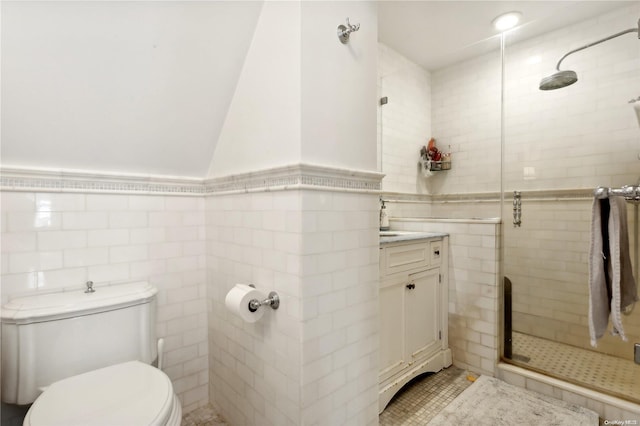 bathroom featuring vanity, tile walls, tile patterned flooring, toilet, and a shower with shower door