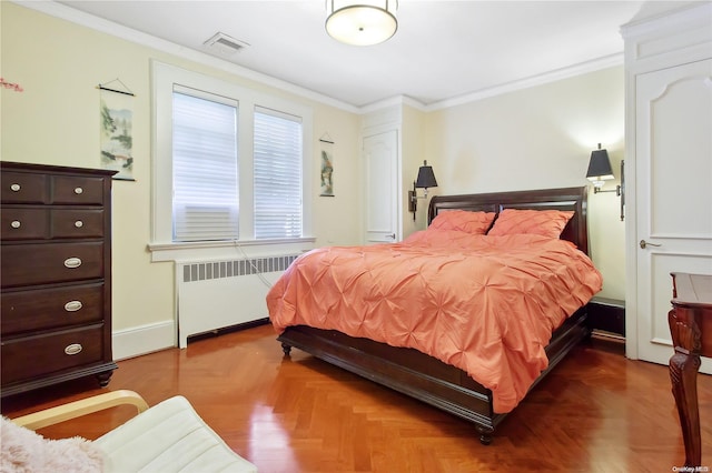 bedroom with radiator heating unit, dark parquet floors, and crown molding